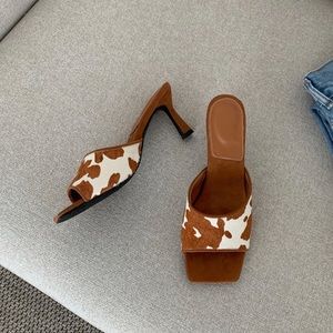 Shop Peche Tara cow print mules